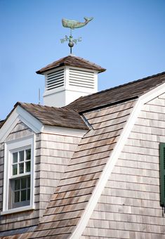 the roof of a house with a weather vane on top