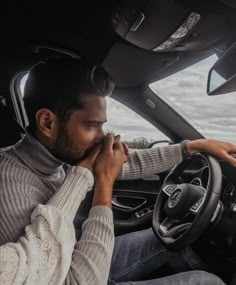 a man sitting in the driver's seat of a car