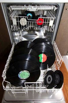 an open dishwasher filled with vinyl records