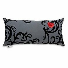 a black and grey pillow with a red heart on it