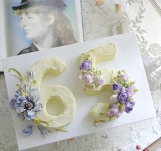 the cake is decorated with flowers and numbers