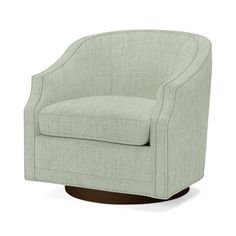 an upholstered swive chair with wood legs and a light green fabric seat