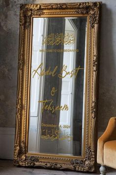 an ornate gold framed mirror sitting on top of a wooden floor