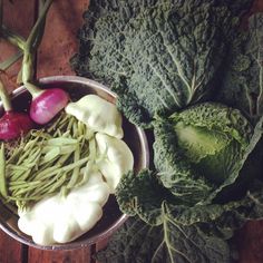 a bowl filled with lots of different types of veggies next to each other