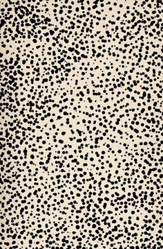 a black and white rug with spots on it