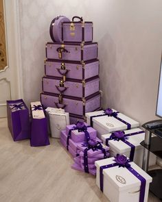 purple and white boxes stacked on top of each other in front of a computer screen