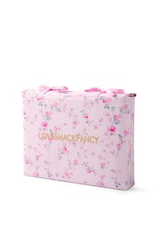 a pink flowered bag with the words loveback fancy on it's side