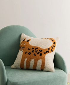 a green chair with a leopard pillow on it