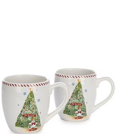 two white coffee mugs decorated with christmas trees