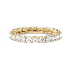 an 18k yellow gold band with round brilliant cut diamonds set in the center, on a white background