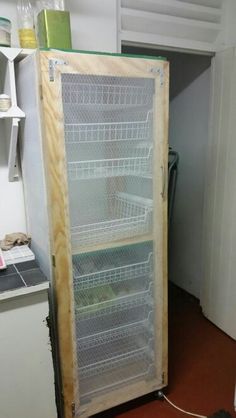 an empty refrigerator in a kitchen with the door open