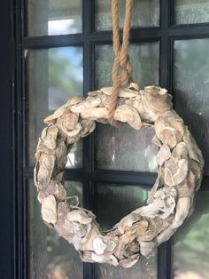 a wreath made out of driftwood hanging from a door