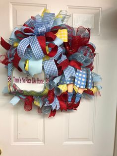 there's no place like home wreath on the front door with red, white and blue decorations