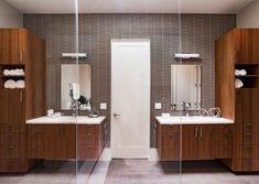 a bathroom with two sinks and mirrors in it