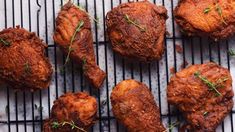 fried chicken on a grill with herbs sprinkled on top