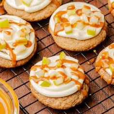 cookies with white frosting and caramel toppings on a cooling rack