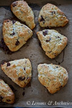 nine scones with raisins and chocolate chips in them on a baking sheet