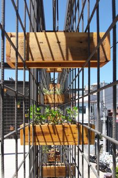 several plants are growing on the side of a metal structure that is being constructed into a planter