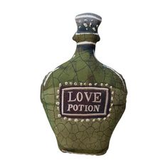 a green ceramic bottle with the words love potion written on it's side