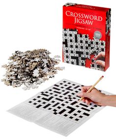 a crossword jigsaw game being held by a person