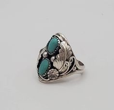 Fancy turquoise sterling silver statement ring.  This amazing ring is crafted in the dome style and is a multi-stone ring featuring stunning detail in the silver work.  This ring has gorgeous 925 sterling silver leaf design and two beautiful cabs of turquoise as its crowning jewel.  This statement piece would make a great gift for dad for a birthday, Valentines Day gift, anniversary or a great graduation or birthday gift!    I only have  few of these rings left, so PLEASE check with me on sizing before ordering!  Also, please check out my other listings in my Etsy shop to find necklaces, bracelets and earrings to compliment this piece. Turquoise Open Ring For Wedding, Heirloom Style Adjustable Sterling Silver Jewelry, Southwestern Engraved Round Rings, Southwestern Style Engraved Round Rings, Collectible Open Rings, Adjustable Silver Turquoise Ring With Gemstone, Fine Jewelry Turquoise Ring, Unique Turquoise Gemstone Ring, Southwestern Silver Open Ring Jewelry