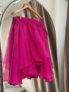 A flowing flared silk skirt cut out of layers of organza, the Freesia Skirt is an image of grace and romance. Wear with your favorite tee or the matching Lin Organza Tee. Elastic silk waistband, delicately lined with silk habotai for coverage. Available in fuchsia. 100% silk organza, silk habotai. Made in New York's Garment District by a small team of dedicated seamstresses. Ships in 10 business days. Silk Ruffled Flowy Skirt, Long Silk Skirt With Ruffles, Summer Lined Organza Skirt, Summer Organza Lined Skirt, Summer Organza Skirt With Lining, Silk Tiered Skirt With Ruffles, Flowy Party Skirt With Ruffles, Summer Long Organza Skirt, Flowy Draped Skirt With Ruffles For Party