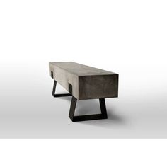 a concrete bench with black metal legs and an open end table on the bottom, in front of a white background