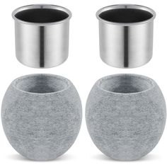 two silver vases sitting next to each other