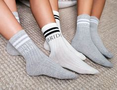 three women's socks with the word bride written on them are sitting next to each other