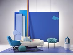 a living room with blue walls and white furniture