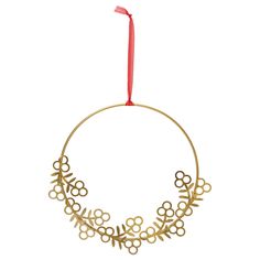 a gold ornament hanging from a red ribbon