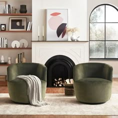 two green chairs sitting in front of a fireplace