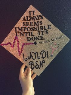 someone is holding up a graduation cap that says it always seems impossible until it's done