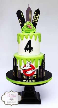 a three tiered cake decorated with green and white icing, featuring ghost characters