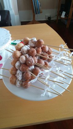 there are many donuts on the plate with toothpicks sticking out of them