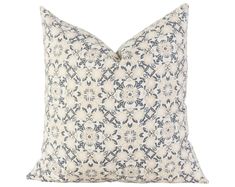 a blue and white pillow with an intricate design on the front, sitting on a white background