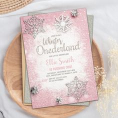 a pink and silver snowflake themed birthday party with the words, once uponland on it