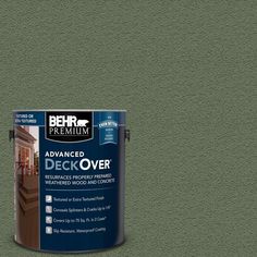 a can of behr premium deck over paint on a gray background with the words,'advanced deck over '