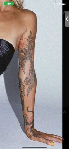 a woman with tattoos on her arm and leg