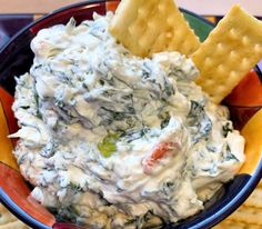 a blue bowl filled with dip and chips