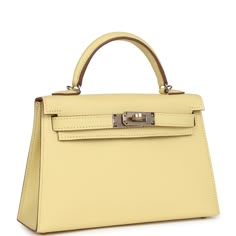 This Special Order Verso Kelly, in the Sellier style, is in Jaune Poussin Epsom leather with permabrass hardware, has tonal stitching, two front straps with front toggle closure, single rolled handle and removable shoulder strap.The interior is lined with Gold leather and has one open pocket on the back wall.Collection: BOrigin: FranceCondition: New and never worn (plastic on hardware)Accompanied by: Hermes box, Hermes dustbag, shoulder strap, shoulder strap dustbag, felt, carebook and ribbonMeasurements: 7.5" width x 4.5" height x 2.2" depth; 2.5" handle drop (18" shoulder strap drop) Hermes Special Order, Kelly Sellier, Mini Kelly, Hermes Birkin 25, Hermes Box, Birkin 25, Burberry Shoes