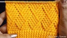 someone is knitting the stitchs on their yellow knitted blanket with a white crochet hook