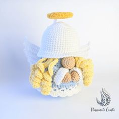 a crocheted angel hat with yellow and white trimmings on the brim