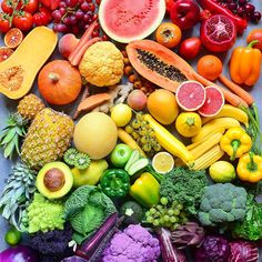 a large assortment of fruits and vegetables are arranged in a square pattern on a table