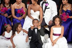 a group of people in formal wear posing for a photo with some children on their wedding day