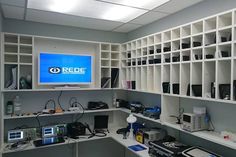 a room filled with lots of electronic devices and electronics on shelves next to each other