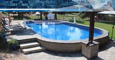 an above ground swimming pool with steps leading up to it and umbrella in the foreground