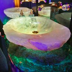 a bathroom sink sitting on top of a counter next to two faucet sinks