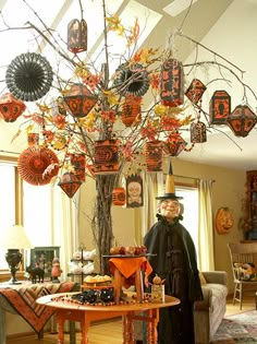 a man standing next to a tree filled with decorations