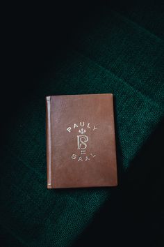 a brown book sitting on top of a green blanket